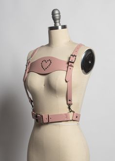 This harness belt is made in thick, strong, colorful PVC or leather. Detachable lederhosen-style front panel with rivet heart detail . Buckles at front and shoulder straps. Fit is adjustable with buckles. Silver-toned nickel plated steel hardware.Shown in blush pink leather.Available in many leather and PVC colors. Neon Pink and Neon Orange PVC are UV/Blacklight reactive! All pieces are MADE TO ORDER, standard sizes XS-4XL. If your measurements fall outside these standards or you are unsure of w Animation Practice, Evil Pics, Harness Outfit, Fall Outside, Concert Style, Harness Belt, Concert Fashion, Colorful Accessories, Leather Diy