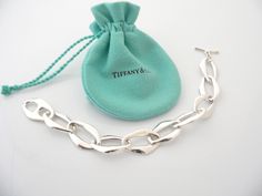 Have you been searching for a piece of Tiffany jewelry that made the brand an icon? You just stumbled upon one of them! Offered for sale is a gorgeous Tiffany & Co. Silver Peretti Aegean bracelet. If you must have just one Tiffany piece ... this should be at the top of your preference list! :) Very substantial and unique Tiffany piece that you will get your money's value for. It is a wonderful bracelet that looks very contemporary, elegant and super chic. The piece looks great worn alone, but wo Box Pouch, Tiffany Jewelry, Bracelet Bangle, Tiffany Heart, Heart Charm Bracelet, Tiffany & Co., Link Chain, You Must, Bangle Bracelets