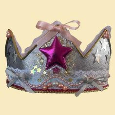 a tiara with pink and silver stars on it