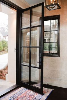 the entrance to a home with glass doors