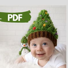 a baby wearing a crocheted christmas tree hat with an owl and snowman on it