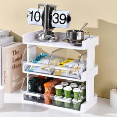 an organized shelf with coffee cups and other items