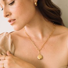 Need a beautiful way to keep a special memory close to your heart? This 14k gold covered elongated link locket is the necklace for you. Have your locket engraved with the initials of your or a loved one’s name. A timeless piece of jewelry that is a favorite with women of all ages that combines classic design with a modern edge. Available in 14k gold plated brass or rhodium plated brass 3/4" locket 18" elongated link paperclip chain with 2" extender Lobster claw closure With engraving this item i Elegant Oval Link Locket Necklace, Elegant Gold Locket Necklace With Oval Link, Elegant Gold Oval Link Locket Necklace, Elegant Oval Link Necklace For Keepsake, Elegant Oval Link Keepsake Necklace, Elegant Oval Link Locket Necklace For Wedding, Medallion Locket Necklace For Keepsakes, Elegant Locket Necklace With Cable Chain For Gifts, Elegant Medallion Locket Necklace With Charms