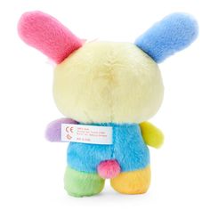 a small stuffed animal with multicolored ears