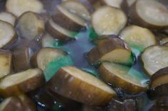 sliced bananas are being cooked in oil on the stove top and water running down the side