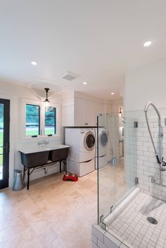 a bathroom with a washer and dryer in it