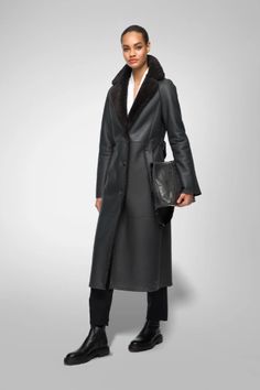 Women's Shearling Leather Coat In Black With Belted Waist Experience luxurious warmth with our women's shearling leather coat in black. Crafted from genuine sheepskin leather with a semi-aniline finish, this coat features a cozy faux shearling inner shell. The elegant fur collar and belted waist add a touch of sophistication, while the button closure and open hem cuffs offer a classic look. Designed with one inside pocket and two side pockets for practicality, this black coat is perfect for both style and comfort. Outer Shell: Genuine Leather Leather Type: Sheepskin Leather Finish: Semi-aniline Inner Shell: Faux Shearling Feature: Big Elegant Fur Collar, Belted Waist Closure Style: Button Collar Style: Fur Collar Cuffs Style: Open Hem Inside Pockets: One Outside Pockets: Two Side Pockets C Sheepskin Fur Coat With Faux Fur Trim For Work, Black Sheepskin Outerwear For Fall, Elegant Sheepskin Fur Coat For Work, Designer Fur Coat For Fall, Leather Fur Coat With Faux Fur Trim For Work, Designer Black Fur Coat For Winter, Elegant Sheepskin Outerwear For Work, Black Sheepskin Leather Jacket For Fall, Winter Formal Leather Fur Coat