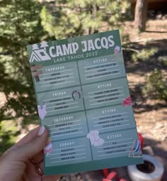 a person holding up a camp jacos flyer