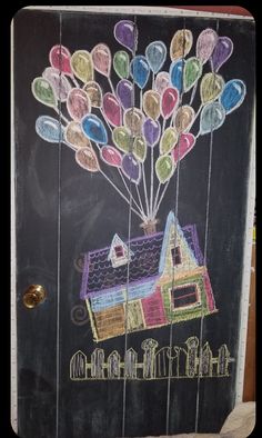 a chalkboard drawing of a house with balloons attached to it