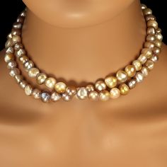 Gorgeous and elegant 32-inch freshwater pearl necklace in shades of gold, mauve, and gray. This unique 8-10mm pearl necklace is luscious. The glowing pearls are a delight to wear. At 32 inches it can possibly be a double strand tightly wrapped. A barrel clasp in gold over sterling is the clasp that secures this unique necklace. Pearls are Mother Nature’s gift from the Sea. They are organic gemstones formed inside either freshwater or saltwater mollusks. The type of mollusk producing the pearl influences the body color. Most mollusks have been assisted by the insertion of a bit natural material inserted into its shell around which it can lay down layers of nacre. These cultured pearls come in a variety of natural colors including gold, white, gray. Pearls can be bleached and dyed to create Water Necklace, Gift From The Sea, Fresh Water Pearl Necklace, Genuine Pearl Necklace, Pearl Necklace Gold, Water Pearl Necklace, Gold Pearl Necklace, Shades Of Gold, Freshwater Pearl Necklace