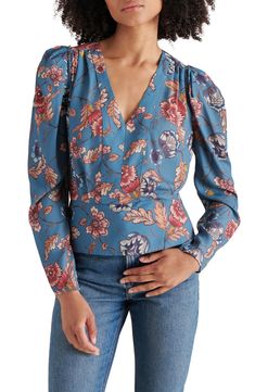 A boho-inspired floral print covers this drapey georgette top framed by puffed sleeves and finished with a silhouette-defining peplum. 22 1/2" length Hidden side-zip closure V-neck Long sleeves with button-and-loop cuffs 100% polyester Hand wash, dry flat Imported Brunch Floral Print Puff Sleeve Top, Brunch Floral Print Puff Sleeve Long Top, Floral Print Long Sleeve Puff Sleeve Top For Brunch, Feminine Floral Print Long Sleeve Puff Top, Feminine Long Sleeve Puff Top With Floral Print, Fitted Long Sleeve Puff Top With Floral Print, Chic Long Sleeve Puff Top With Floral Print, Chic Floral Print Puff Sleeve Top With Lantern Sleeves, Chic Puff Sleeve Top With Floral Lantern Sleeves