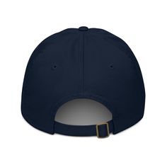 the back of a navy baseball cap with a gold buckle on it's peak