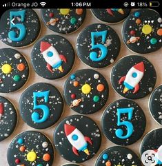 there are many decorated cookies with numbers and rockets on them in the shape of planets