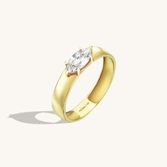 The Marquise Bold Band Ring will demonstrate your taste with elegancy and gather all attention around you with its marquise cut original design. It is crafted to elevate your appearance on its own. - Made in 14k solid gold- Decorated with handset white coloured cubic zirconia stone on 14k solid gold- Band Width: 3.66 mm / 0.144 inches - Thickness: 1.20 mm / 0.047 inches- This product comes with iconic Norm Jewels gift box Elegant Marquise Diamond Promise Ring, Cubic Zirconia Rings With Single Diamond In Marquise Cut, Modern Jewelry With Marquise Diamond Cut, 14k Gold Marquise Cut Diamond Ring With Tension Setting, Modern Marquise Jewelry For Formal Occasions, Gold Marquise Single Diamond Wedding Ring, Promise Ring With Single Diamond In Marquise Shape, Yellow Gold Marquise Cut Jewelry With Tension Setting, Modern Marquise Cut Cubic Zirconia Wedding Ring