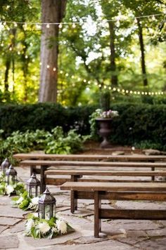 a row of wooden benches sitting next to each other on top of a stone floor