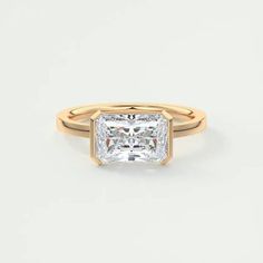 a gold ring with a princess cut diamond