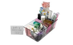 a clear plastic container filled with cosmetics and personal care items on top of a white background