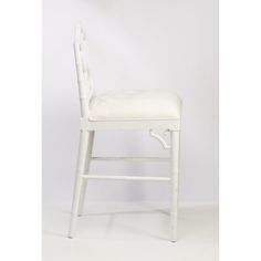 a white chair against a white wall