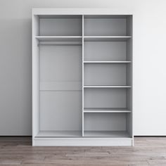 an empty white bookcase in a room with wood flooring and gray wall paint