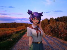 a woman standing on a dirt road talking on a cell phone