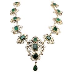 Transport yourself to a world of timeless beauty and sophistication with this extraordinary antique Victorian era graduated necklace. Adorned with mesmerizing emeralds and dazzling diamonds, this exquisite piece captures the essence of a bygone era. The necklace showcases a captivating arrangement of graduated emerald gemstones, carefully selected for their rich green color and exquisite clarity. Each emerald is meticulously set in an intricate scroll motif link crafted from lustrous 14K yellow Luxury Vintage Rose Cut Diamond Necklace, Luxury Victorian Flower Pendant Jewelry, Luxury Antique Jewelry With Rectangular Stone, Elegant Ceremonial Emerald Necklace With 17 Jewels, Formal Emerald Necklaces With Single Cut Diamonds, Elegant Formal Emerald Necklace With Intricate Design, Vintage Diamond Gemstone Necklace, Antique Green Jewelry With Single Cut Diamonds, Vintage Diamond Necklace With Gemstones