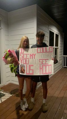 two people standing on a porch holding flowers and a sign that says, if you could see my heart you will see me too