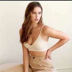 Ribbed V-Neck Seamless Bralette (Pearled Ivory) Perfect Add On To Your Closet To Wear Under A Staple Blazer! Materials: 92% Nylon/8% Spandex Model Is 5'4 And Wearing A Size O/S Elegant V-neck Bra For Spring, Beige Seamless V-neck Crop Top, Chic Seamless Low-cut Bra, Elegant V-neck Summer Bra, Ribbed Fitted Bra, Elegant V-neck Bra, Chic Seamless Bra For Spring, Seamless Beige Bra For Spring, Beige Triangle Top Crop Top