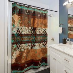 a bathroom with a shower curtain that has an abstract design on it, along with a sink and mirror