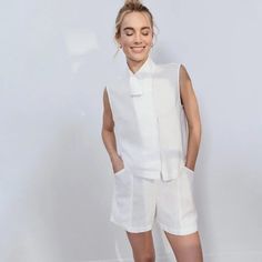 Slip Into Summer Vacay Mode With The Woven Linen Sleeveless Shirt. Made Of 100% European Flax Linen For A Naturally Soft Texture Finish And Lightweight Feel, It’s Made To Carry You From Lounging At Home To Your Next Dreamy Destination. Featuring A Front Color Asymmetrical Neckline With Hidden Snap Closure Design, It’s Perfect For Naptime On The Lounge Chair, To Being That Stylish Weekender (Who Also Enjoys Sleeping In). Made From 100% European Flax And Non Toxic Dyes, The Weave Is Light, Natural Sleeveless Linen Vest For Daywear, White Linen Sleeveless Vest, Sleeveless Summer Workwear Vest, Summer Sleeveless Workwear Vest, Sleeveless Linen Summer Vest, Summer Workwear Vest Tops, White Tank Top For Summer Workwear, Chic Sleeveless Summer Vest, Sleeveless Linen Vest For Day Out