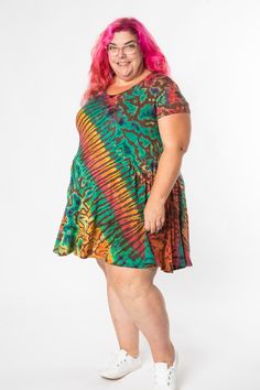 Our best-selling Althea Mudmee Tie Dye Dress in a summer-friendly short-sleeve version! This stretchy tie dye tunic dress features charming pockets and is the ultimate instant easy outfit—accessorize with some sparkling gemstone jewelry and a few boho bangles and you are ready to shine! Look no further for your new favorite colorful cozy dress with a heavy pinch of hippie-fication! Casual Short Sleeve Summer Dress With Relaxed Fit, Casual Short Sleeve Dress With Relaxed Fit For Summer, Casual Fitted Tie Dye Mini Dress, Fitted Mini Dress With Short Sleeves For Festivals, Casual Green Short Sleeve Dress For Summer, Casual Flowy Tie-dye Dress, Casual Tie Dye Mini Dress, Casual Tie Dye Dress For Festival, Casual Tie Dye Festival Dress