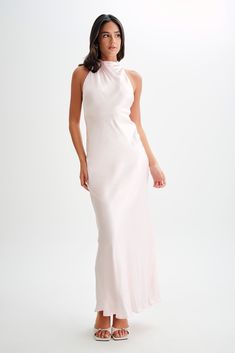 Exude elegance.Make a statement in our ESTHER Iridescent Satin Cowl Maxi Dress, a captivating blend of elegance and allure. Featuring a cowl halter neckline that beautifully frames the décolletage and a low v-back that exudes sophistication, this dress is designed to turn heads. Adorned with self-covered buttons at the back and a side invisible zip for ease of wear, it combines practicality with style. Lined for comfort and a relaxed fit for effortless movement, this dress is the epitome of understated glamour. Capsule Wardrobe Accessories, Understated Glamour, Dresses Date Night, European Summer Outfits, Black Dress Prom, Maxi Dress Sale, Capsule Outfits, Beige Dresses, Date Night Dresses