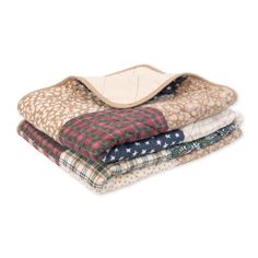 four blankets stacked on top of each other in different colors and patterns, with one blanket folded