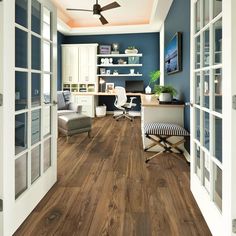 an office with wood floors and blue walls