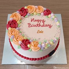 a birthday cake with flowers on it sitting on a table