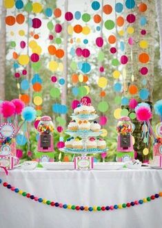 a table topped with lots of cake and cupcakes