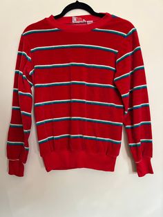 "Vintage 80s Stripes by Tomboy velour shirt. Awesome velvet casual long-sleeved tee, with very 80s stripes of blue, green, and white against a bright red background. Sleeve cuffs, neckline, and bottom of shirt in sweatshirt material. Shirt is cotton/poly blend and very soft. Size small, and that is accurate even for modern sizing, but there is stretch. Shirt also tapers a bit at the waist. Would rock it with a pair of jeans and some Vans. Shirt is in good vintage condition, some pilling at the c Cheap Retro Red Shirt, Retro Red Long Sleeve Sweatshirt, Red Retro Long Sleeve Sweatshirt, Retro Red Tops For Winter, 90s Red Long Sleeve Tops, Red Retro Winter Tops, Retro Red Long Sleeve Top, Red Retro Long Sleeve Top, 90s Style Red Tops For Winter