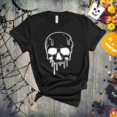 a black t - shirt with a white skull on it and spooky eyes