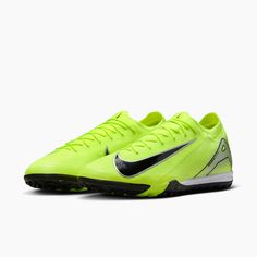 a pair of yellow and black nike soccer cleats on a white background,