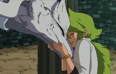 a woman with green hair hugging a white wolf