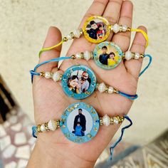 a person holding three different pictures in their hand with beaded bracelets on them