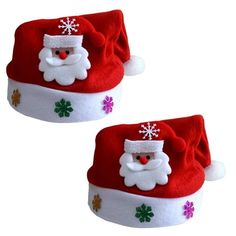 two red santa hats with white and green decorations