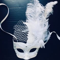 white wedding mask for women with glitter and feathers. Easy to wear and remove! All Masks come with matching Ribbons attached.  Matching Men's Mask available is also available in White color  Thank you for supporting small businesses and hope our products bring you and loved ones some joy and humor in these trying times.  S H I P P I N G  -   Current processing times range 5-7 days. Pls note expedited & 1-2 day guaranteed delivery services offered will still require the same processing times. White Feather Mask, White Masquerade Mask, White Masquerade, Ball Masks, Masquerade Mask Women, Mask White, Metal Mask, Ball Mask, Feather Mask