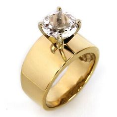 a yellow gold ring with an oval cut diamond