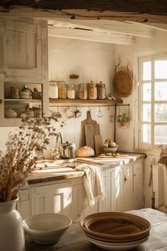 an old fashioned kitchen with white cabinets and wooden counter tops is seen in this image