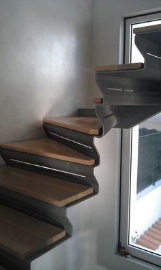 a set of wooden stairs next to a window