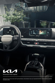 the interior of a car with dashboard and touchscreens, including an info display