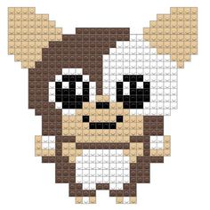 an animal made out of legos with black eyes and brown ears, sitting on top of