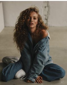 a woman sitting on the ground with her legs crossed