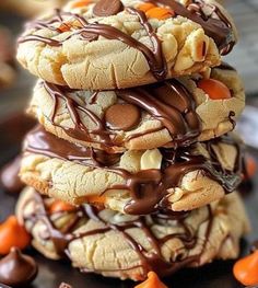 a stack of cookies with chocolate drizzled on top and candy candies