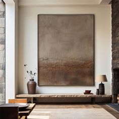 a living room with a large painting hanging on the wall next to a couch and coffee table